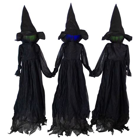 Witch figurine holding stakes for Halloween